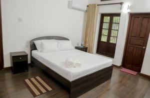 Postel nebo postele na pokoji v ubytování Villa Kengalle