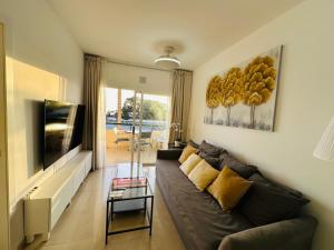 a living room with a couch and a television at Apartment in front of the ocean in Los Cristianos +25 photos