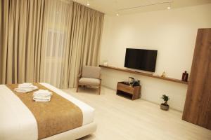a hotel room with a bed and a television at A Gallery Hotel in Shkodër