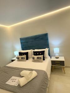 a bedroom with a large bed with a blue headboard at Ocean Whisper Room 6 minutes away from the beach in Cape Town +53 photos