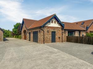 a large brick house with a driveway at Valentines Cottage - Uk48509 in Kirk Hammerton