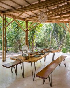a long wooden table with benches under a pavilion at Awakening Sanctuary in Santa Cruz