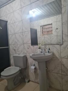 a bathroom with a toilet and a sink at Pousada Pôr do Sol in Belém