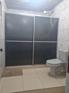 a bathroom with a shower stall with a toilet at Pousada Pôr do Sol in Belém