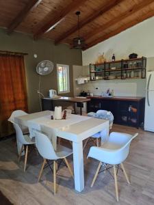 a kitchen with a table and chairs in a room at Beautiful Quinta in Corrientes in Paso de la Patria