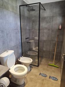 a bathroom with a toilet and a glass shower at Beautiful Quinta in Corrientes in Paso de la Patria