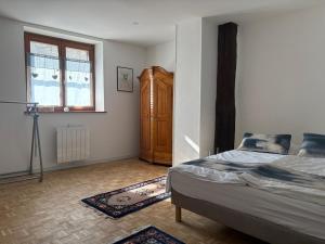 a bedroom with a bed and a dresser in it at La Belle Mélusine in Bergheim