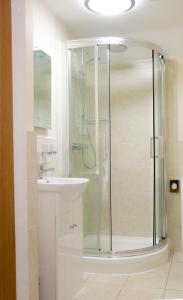 a bathroom with a shower and a sink at Gradbach Mill B&B in Buxton