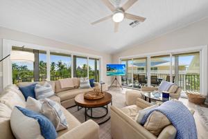 a living room with couches and a ceiling fan at Surfside 12 A4 in Sanibel