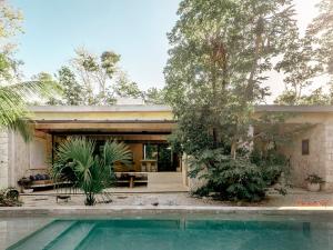 a house with a pool in front of it at Casa M in Macario Gomez