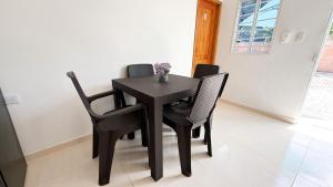 a black table and chairs in a room at Cabaña Datalu 2 in Coveñas