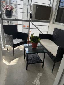 a balcony with two chairs and a couch and a table at Comfort and tranquility in one place in La Estrella