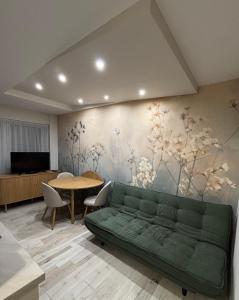 a living room with a green couch and a table at HelloWine Apartman in Eger +11 photos