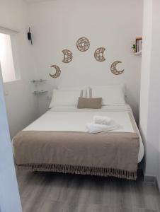 a bedroom with a large bed with white sheets at Orion's Moon in Las Eras