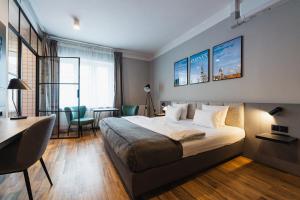 a hotel room with a bed and a desk and a desk at Stary Rynek - Old Market Apartments Poznań in Poznań