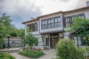 an old stone house with a stone wall at Pachilov House in Zlatograd