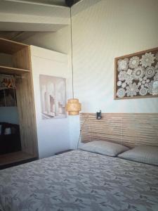 a bedroom with a bed and a picture on the wall at Sea waves suite in Hersonissos +1 photo