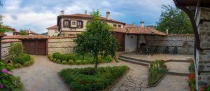 a large house with a courtyard in front of it at Pachilov House in Zlatograd +5 photos