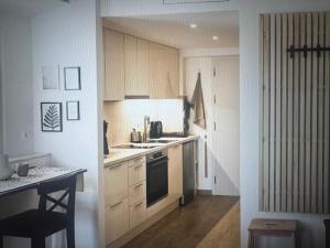 a kitchen with white cabinets and a stove top oven at Sea waves suite in Hersonissos