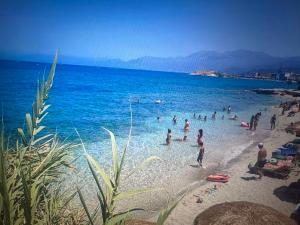 a group of people in the water at a beach at Sea waves suite in Hersonissos