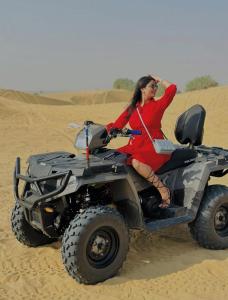 a woman sitting on a quad bike in the desert at HP Desert Luxury Camp in Jaisalmer