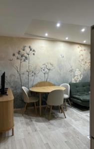 a dining room with a table and a wall mural at HelloWine Apartman in Eger