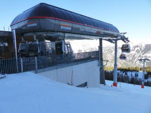 a ski lift with people on it in the snow at Apartment Lisa Hinterstoder in Hinterstoder +10 photos