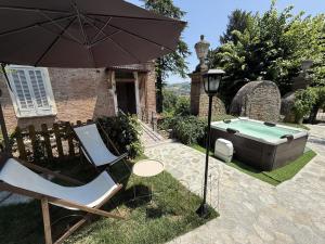 a couple of chairs and an umbrella next to a pool at Io&Te La Suite di Villa Monteriolo in Canelli
