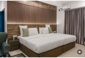 Un dormitorio con una cama grande con cabecero de madera. en Starview Terrace Hotel, en Badore