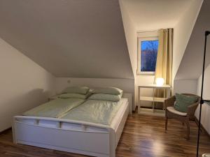 a bedroom with a bed and a window at Schöne Wohnung mit Aussicht in Oettingen in Bayern