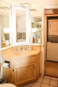 a bathroom with a sink and a mirror at 2b2b AC Magic Tides Kona near Magic Sands Beach in Kailua-Kona