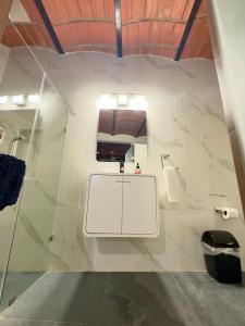 a bathroom with a bench and a toilet at Palapa Chili # in Sayulita +60 photos
