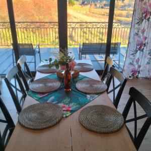 a table with chairs and a vase of flowers on it at Siedem Światów Domek in Jurgów +14 photos