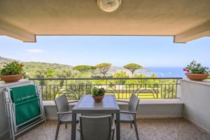 a balcony with a table and chairs and the ocean at Appartamenti Ischia la Sentinella in Ischia