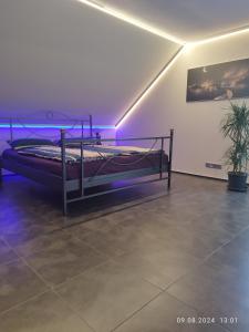 a bed in a room with purple lights at Ferienwohnung Jessica in Mastershausen