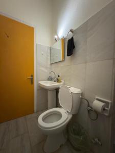 a bathroom with a toilet and a sink at Blue Note in Mytilini +6 photos