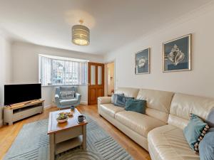 a living room with a couch and a tv at 4 Bed in Llandudno 89703 in Deganwy