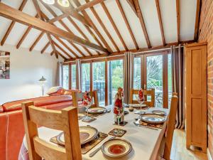 a dining room with a table and a couch at 2 Bed in Digby 91059 in Ashby de la Launde