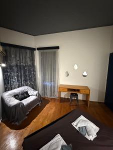 a living room with a bed and a desk at Blue Note in Mytilene