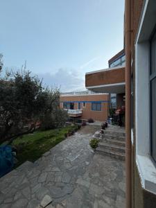 a building with a stone walkway next to a building at Blue Note in Mytilini