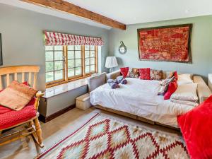 a bedroom with a bed and a chair and windows at 4 Bed in Icklesham BT067 in Icklesham