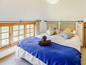 a teddy bear sitting on a bed in a bedroom at 4 Bed in Icklesham BT067 in Icklesham +50 photos