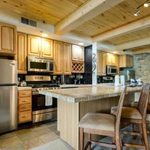 a kitchen with wooden cabinets and stainless steel appliances at Aspen Chic in Aspen