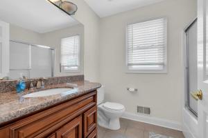 a bathroom with a sink and a toilet and a mirror at Aspen Chic in Aspen +4 photos