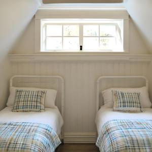 two beds in a room with a window at Aspen Chic in Aspen