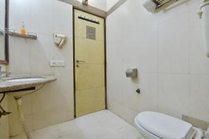 a bathroom with a toilet and a sink at Hotel Blue Star - Paharganj Delhi in New Delhi