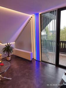 a living room with a staircase with blue lights at Ferienwohnung Jessica in Mastershausen