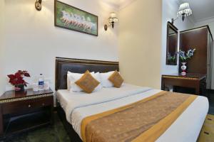 a hotel room with a bed and two night stands at Hotel Blue Star - Paharganj Delhi in New Delhi +14 photos