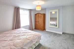 een slaapkamer met een bed en een grote spiegel bij Hill View in Charlton