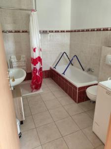 a bathroom with a tub and a toilet and a sink at Fewo Kretsche in Boxberg